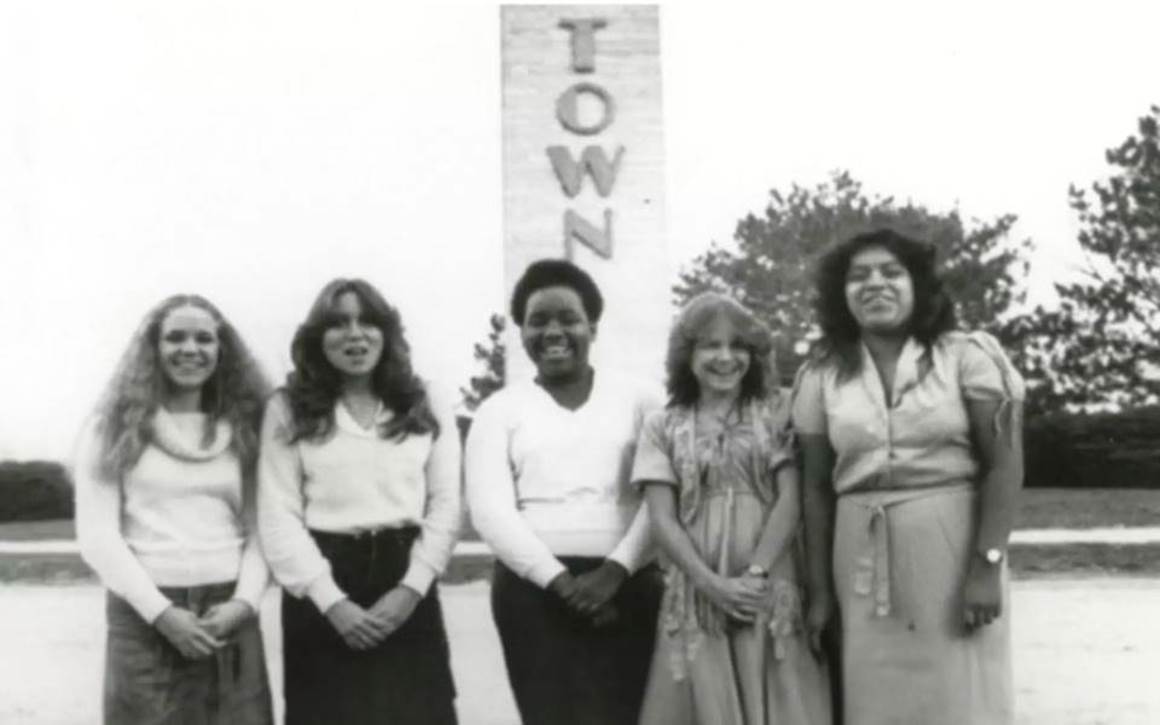 black and white photo of woman at boys town in front of the pilon